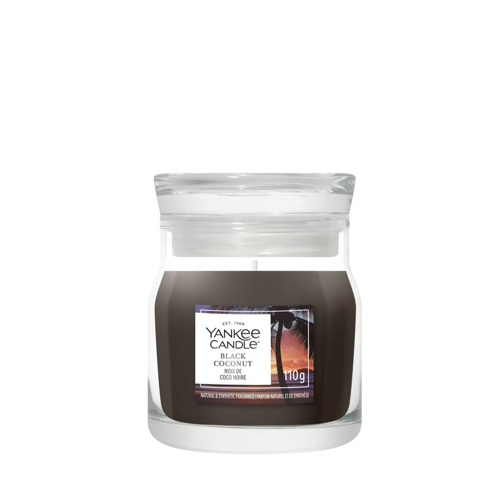 Yankee Candle Black Coconut , black candle, Clear glass vase with beach design on the label, on a white background