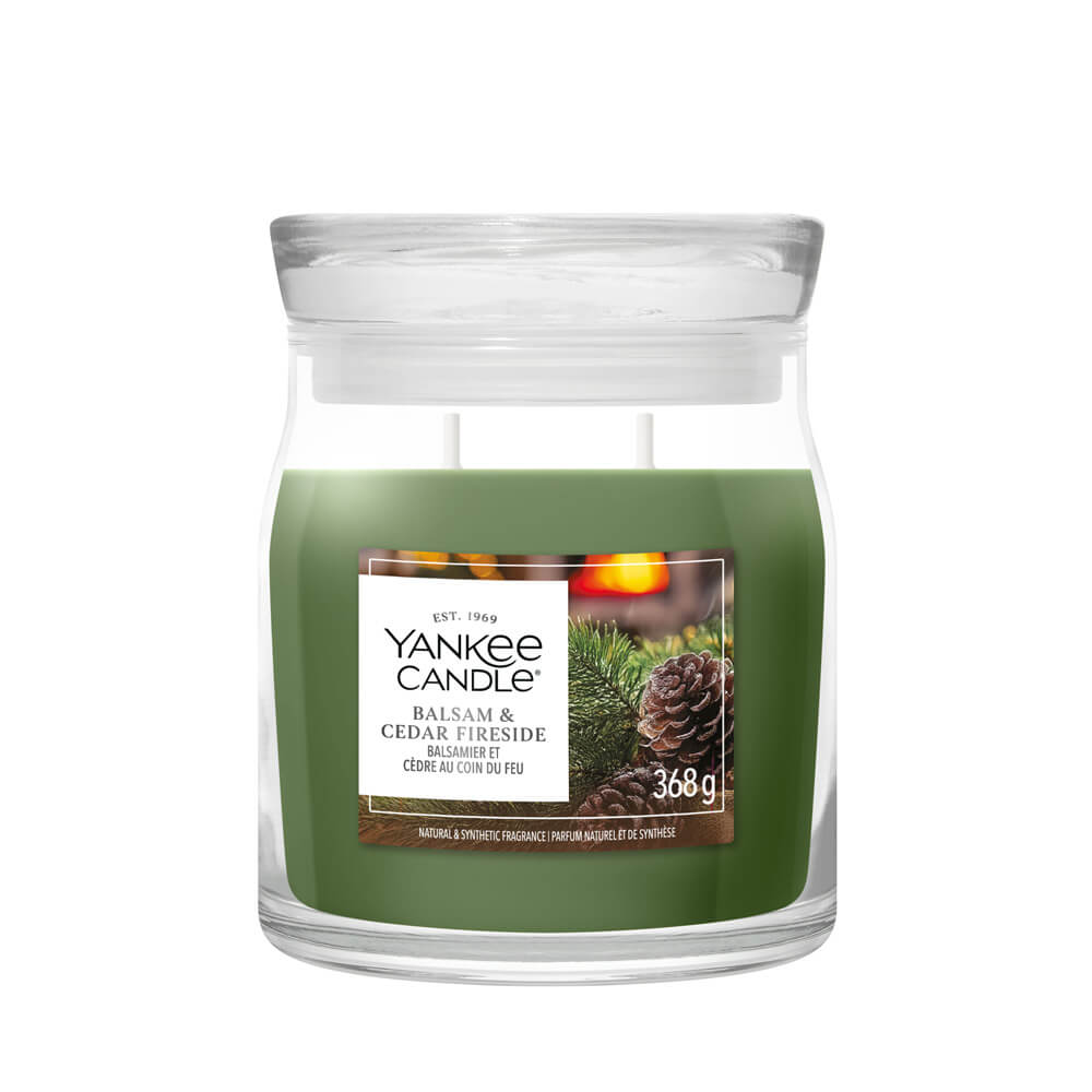 Yankee Candle Balsam & Cedar Fireside candle in a glass jar on a white background