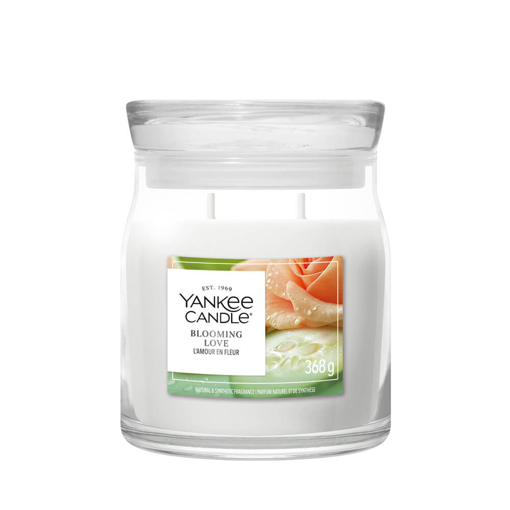 Yankee Candle Blooming Love candle in a clear glass jar on a white background
