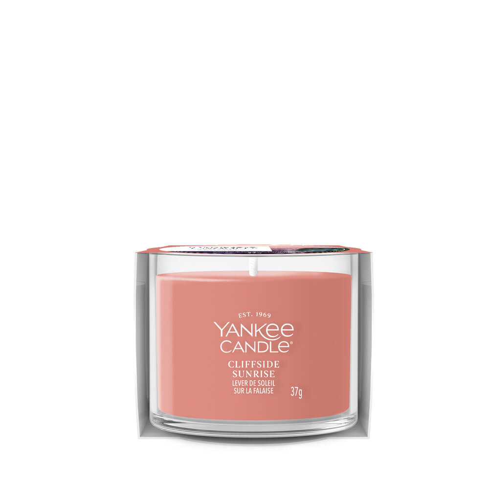Yankee Candle Clifftside Sunrise candle in a clear glass jar on a white background